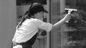 girl cleaning a glass window